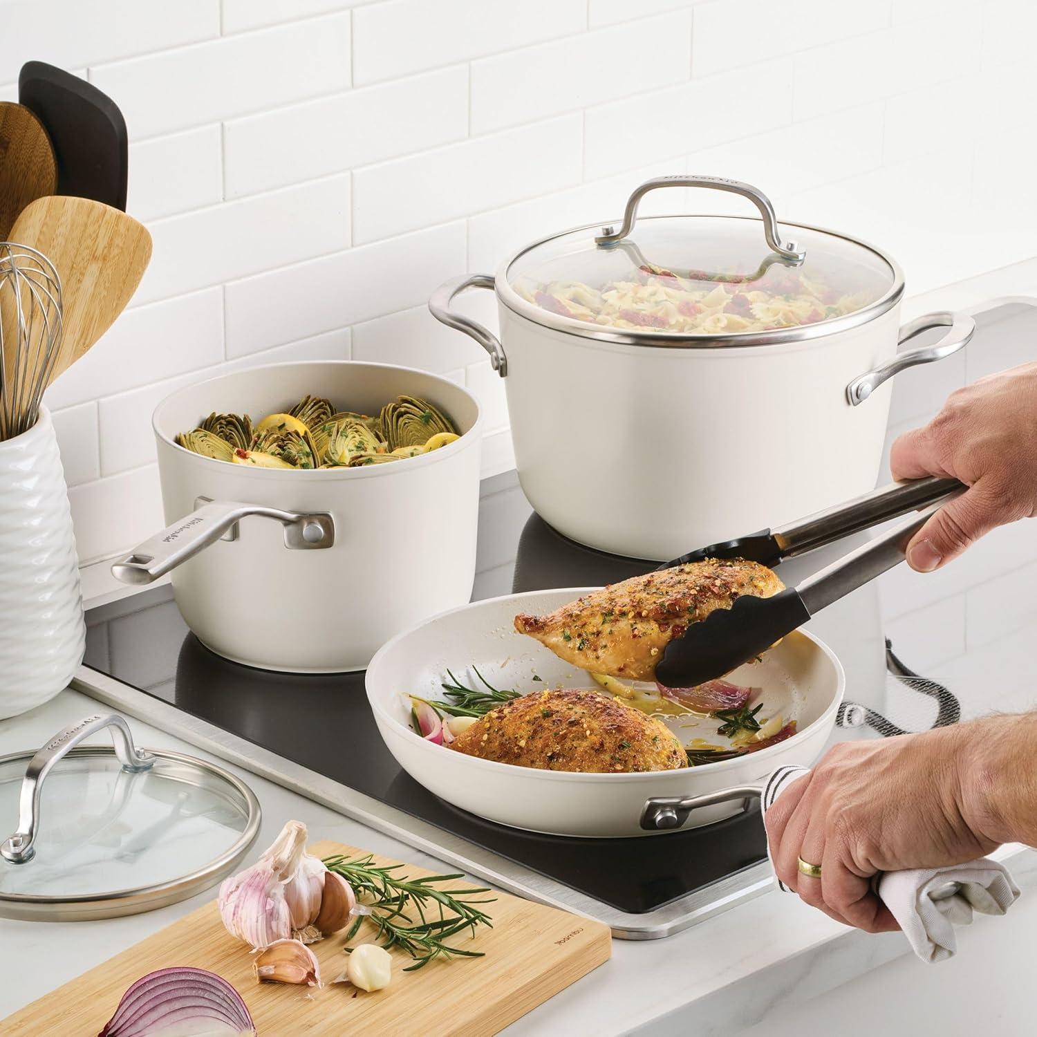 imageKitchenAid Hard Anodized Ceramic Induction Nonstick Pots and Pans with Saucepans Frying Pans Stockpot and Lids Dishwasher Safe 9 Piece Cookware Set with Stainless Steel Handles Porcelain WhitePorcelain